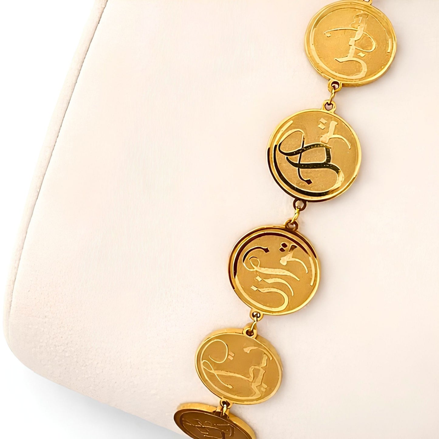 Close-up detail of the FABLED Remember gold plated coin calligraphy bracelet