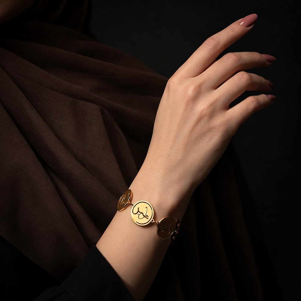 Gold coin bracelet featuring Arabic calligraphy by FABLED