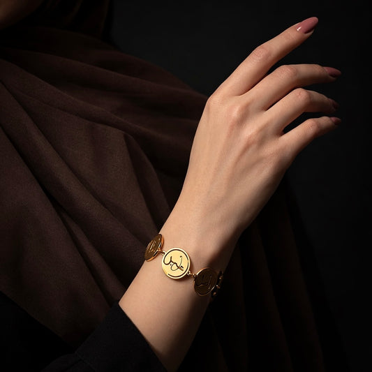 Gold coin bracelet featuring Arabic calligraphy by FABLED