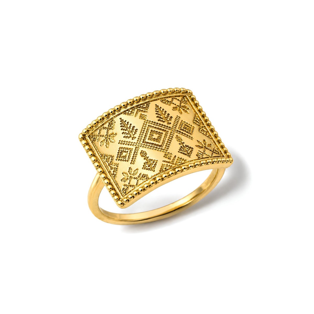 A tatreez-inspired motif set against an antique-finished golden backdrop and framed within a rectangular statement gold plated ring on a white background. 