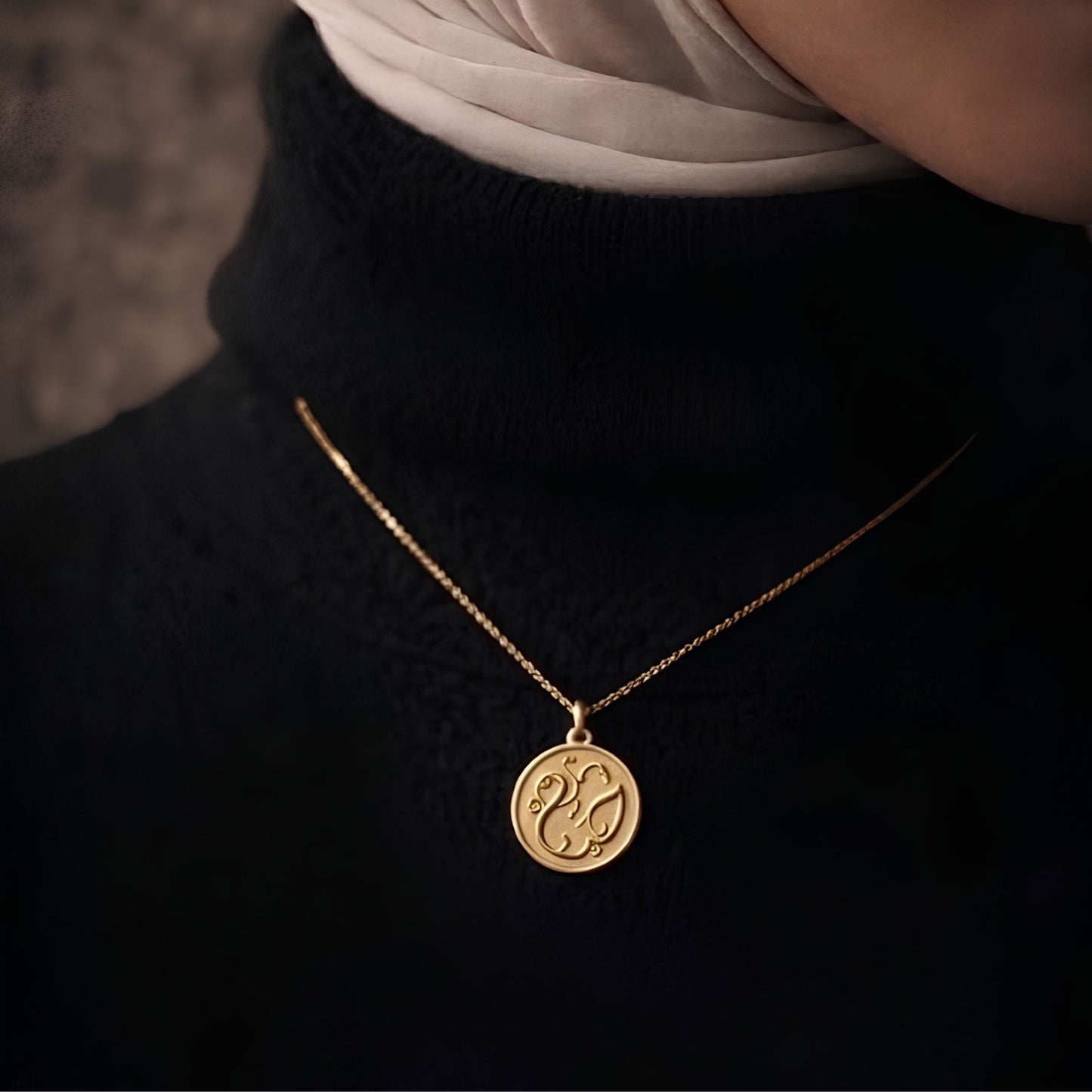 Gold plated haya coin necklace featuring Arabic calligraphy by FABLED