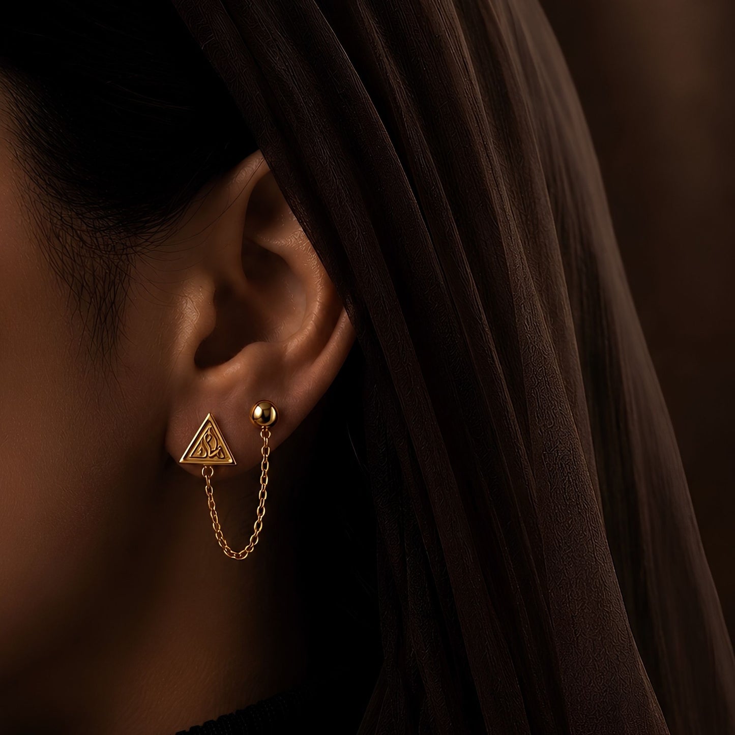 Gold plated iman double piercing earring featuring Arabic calligraphy by FABLED