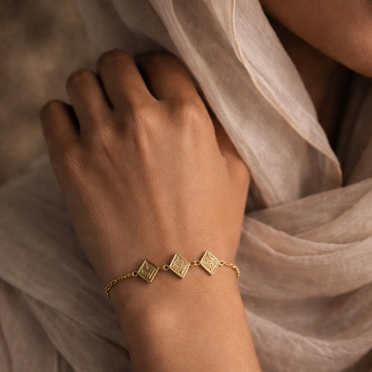 Gold maktub bracelet featuring Arabic calligraphy by FABLED