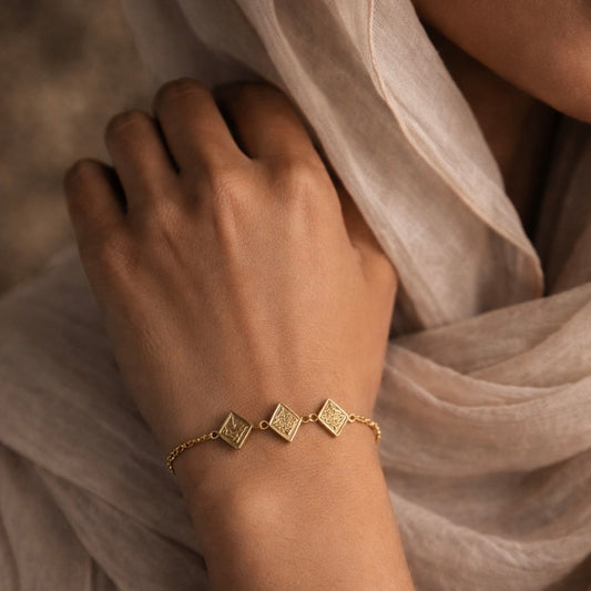 Gold maktub bracelet featuring Arabic calligraphy by FABLED