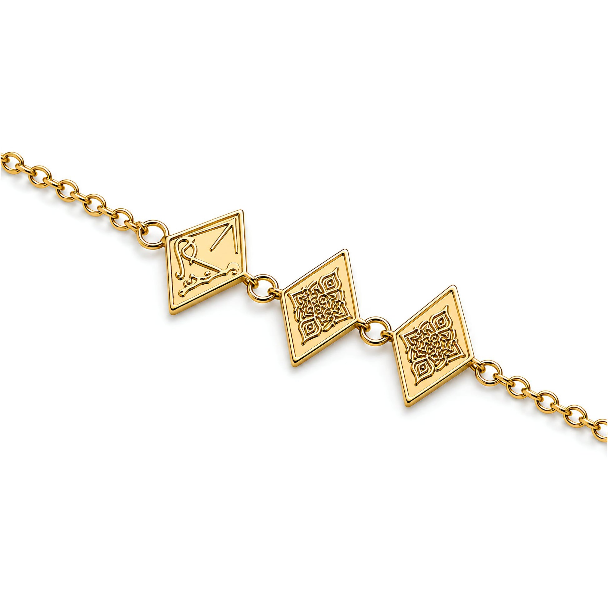 A gold chain bracelet featuring three diamond-shaped charms with engraved patterns and arabic calligraphy saying Maktub, shown against a plain white background.