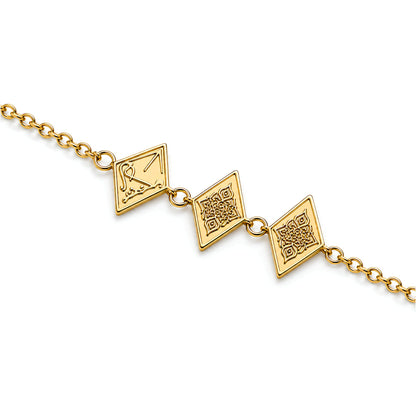 A gold chain bracelet featuring three diamond-shaped charms with engraved patterns and arabic calligraphy saying Maktub, shown against a plain white background.