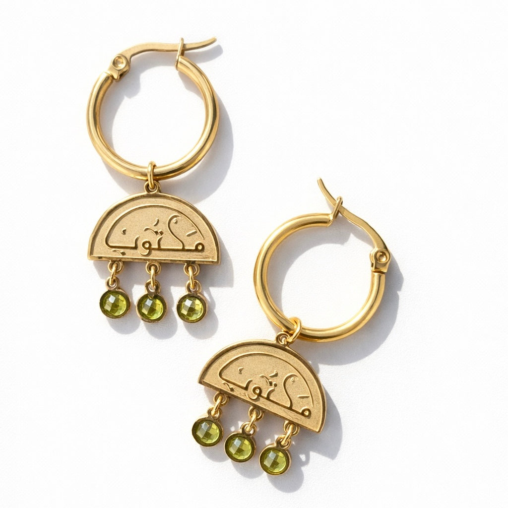 Close-up detail of the FABLED gold plated maktub calligraphy earring 