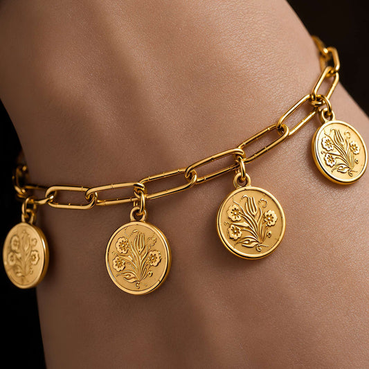 A floral bouquet pattern on a traditional coin charm bracelet made minimalist for daily wear shown worn on a wrist against a dark background.