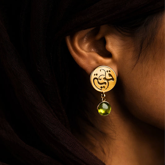 Gold plated qawiyyah earring featuring Arabic calligraphy by FABLED