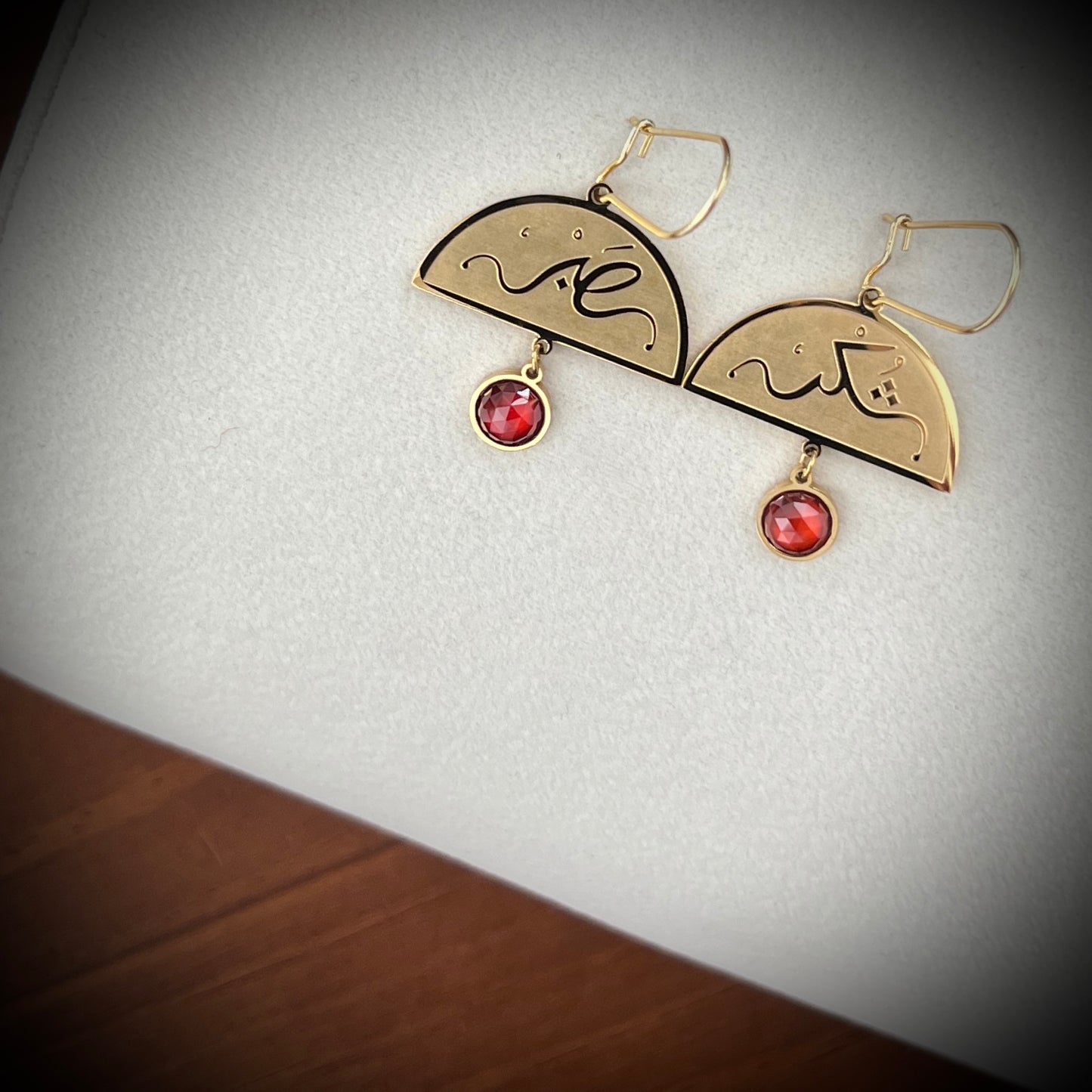 Close-up detail of the FABLED gold plated Sabr and shukr calligraphy earring 