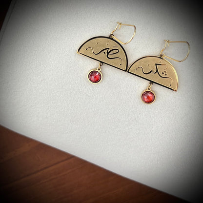 Close-up detail of the FABLED gold plated Sabr and shukr calligraphy earring 