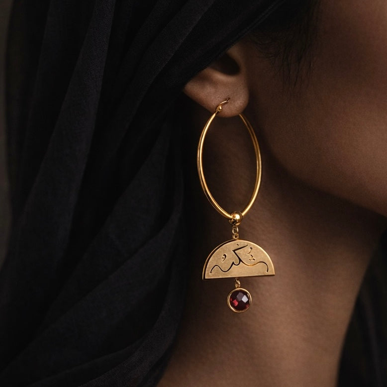 Gold Sabr and Shukr hoop earrings featuring Arabic calligraphy by FABLED