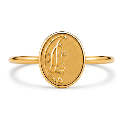 Close-up detail of the FABLED gold plated Salaam calligraphy ring  against a white background.