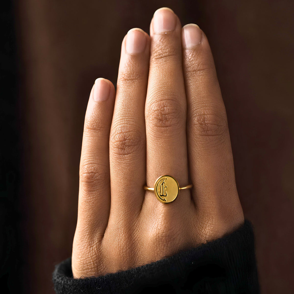 Gold plated Salaam ring featuring Arabic calligraphy by FABLED, set against a dark brown background.