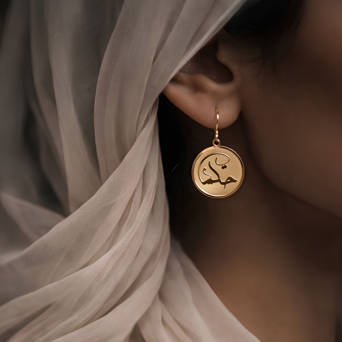 Gold hikma earring featuring Arabic calligraphy by FABLED