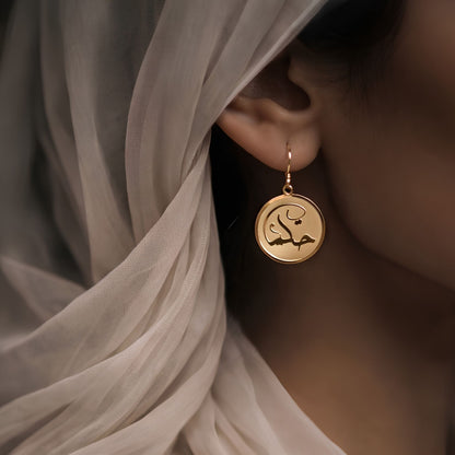 Gold hikma earring featuring Arabic calligraphy by FABLED