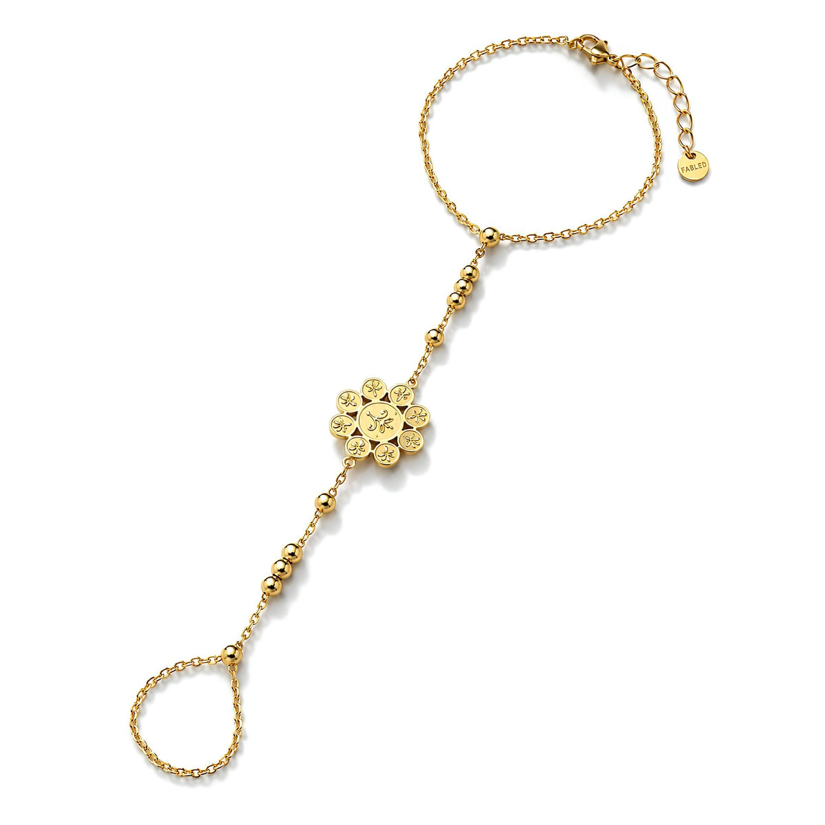 Gold hand chain bracelet with stylized rosette motif sketched on the parts and petals of a classic floral pendant on a white background.