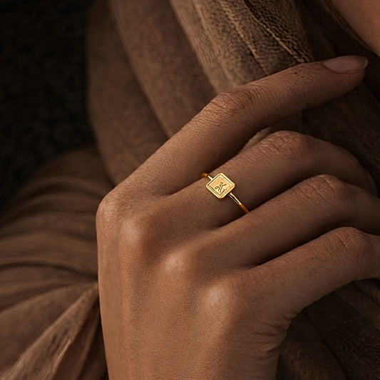 Gold tawakkul square ring featuring Arabic calligraphy by FABLED