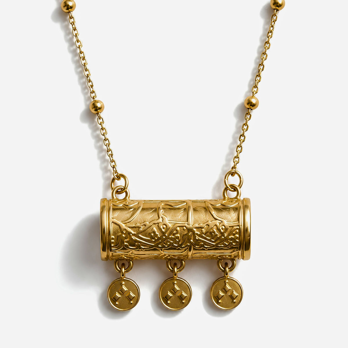 Gold plated traditional middle eastern necklace with intricate pendant and hanging elements on a white background