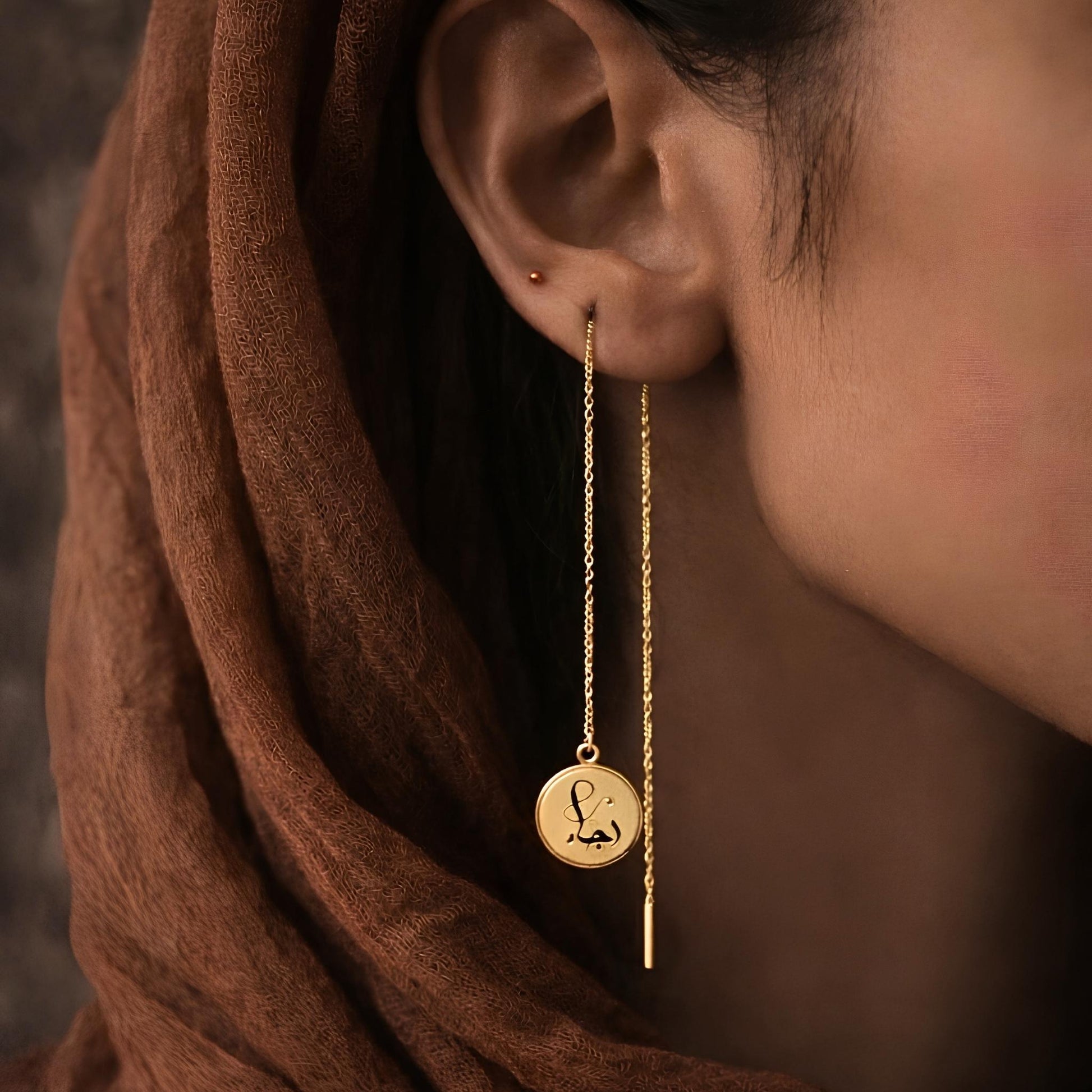 Gold threader earring featuring Arabic calligraphy by FABLED